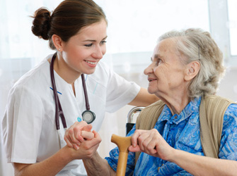 Senior woman is visited by her doctor or caregiver